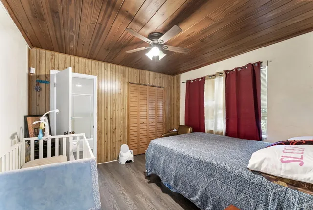 a bedroom with a large bed and a large window