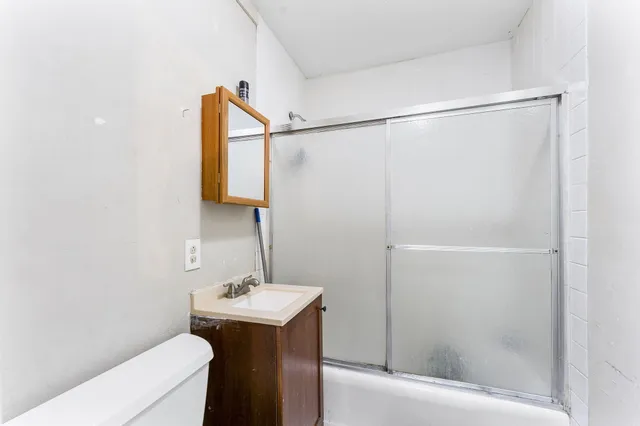 a bathroom with a sink a mirror and a shower