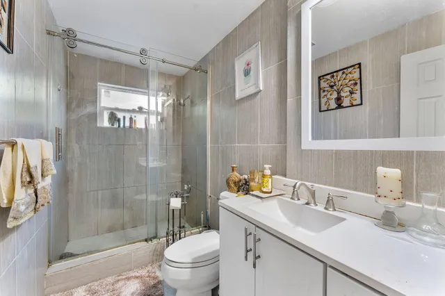 a bathroom with a sink toilet and shower