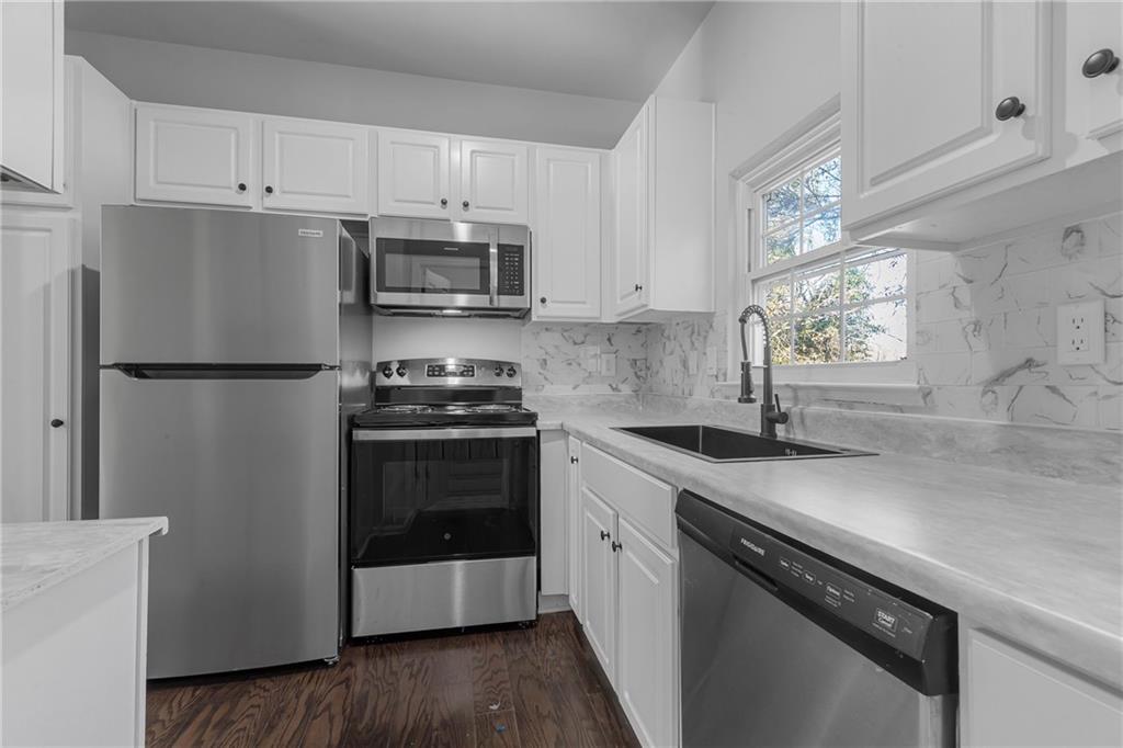 1731 Pryor Road Southwest, Unit 301 Atlanta, GA 30315 - Photo 13 of 29 a kitchen with granite countertop a refrigerator sink and stove