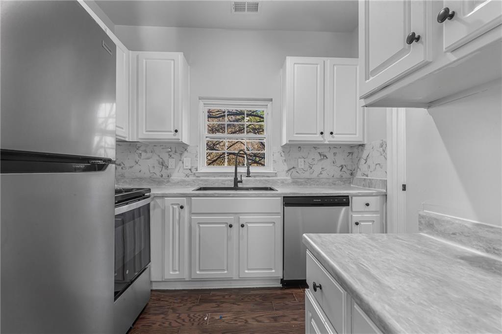 1731 Pryor Road Southwest, Unit 301 Atlanta, GA 30315 - Photo 14 of 29 a kitchen with a stove sink and cabinets