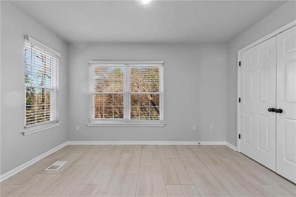 1731 Pryor Road Southwest, Unit 301 Atlanta, GA 30315 - Photo 16 of 29 a view of an empty room with wooden floor and a window