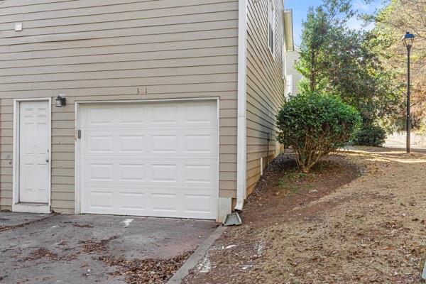 1731 Pryor Road Southwest, Unit 301 Atlanta, GA 30315 - Photo 23 of 29 a view of a house with a yard and garage