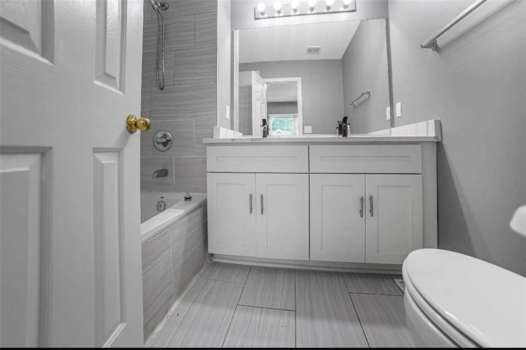 1731 Pryor Road Southwest, Unit 301 Atlanta, GA 30315 - Photo 3 of 29 a bathroom with a sink a toilet and mirror