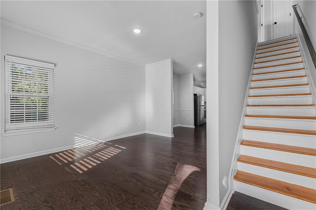 1731 Pryor Road Southwest, Unit 301 Atlanta, GA 30315 - Photo 6 of 29 a view of a room with wooden floor and stairs
