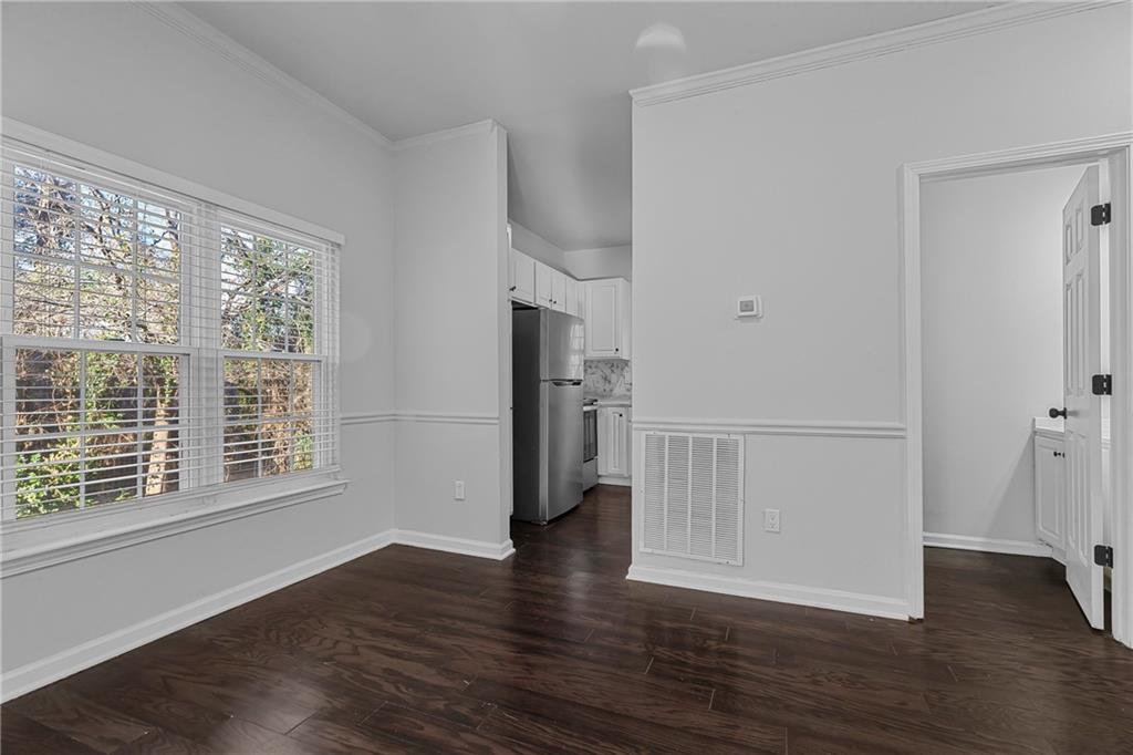 1731 Pryor Road Southwest, Unit 301 Atlanta, GA 30315 - Photo 8 of 29 a view of an empty room with wooden floor and a window