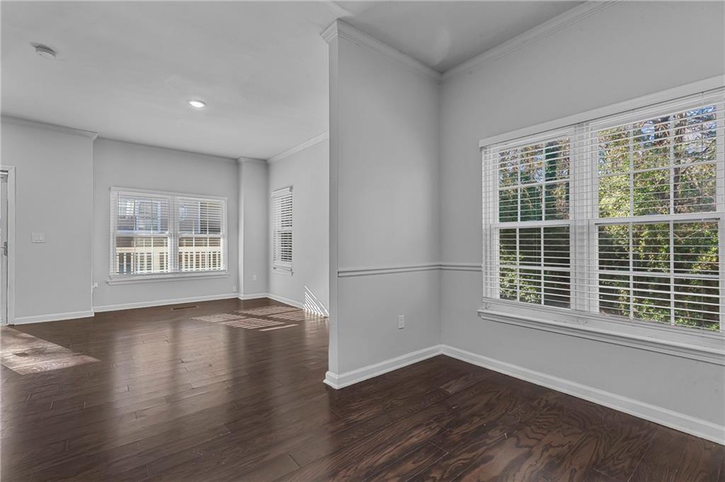 1731 Pryor Road Southwest, Unit 301 Atlanta, GA 30315 - Photo 10 of 29 a view of an empty room with wooden floor and a window