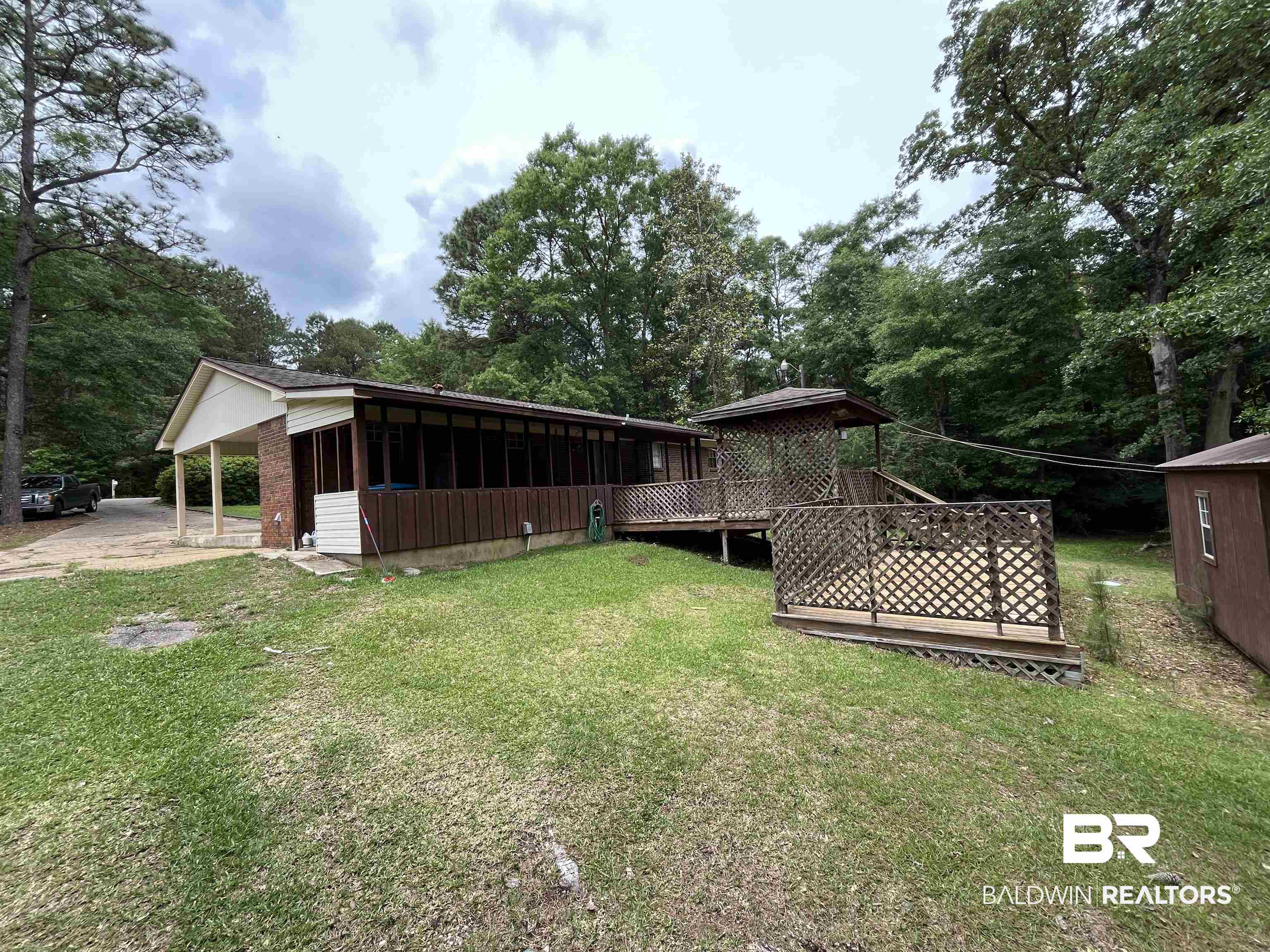 1905 Rockaway Creek Road Atmore, AL 36502 - Photo 3 of 23 Expansive property featuring a screened porch, covered carport, and a multi-level wooden deck with a gazebo