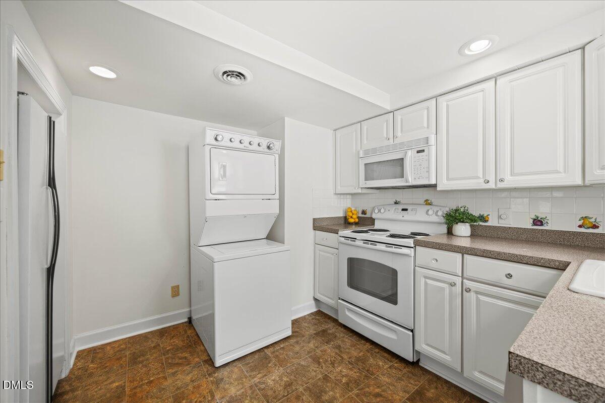 1627 Sutton Drive Raleigh, NC 27605 - Photo 10 of 33 a kitchen with white cabinets and white appliances