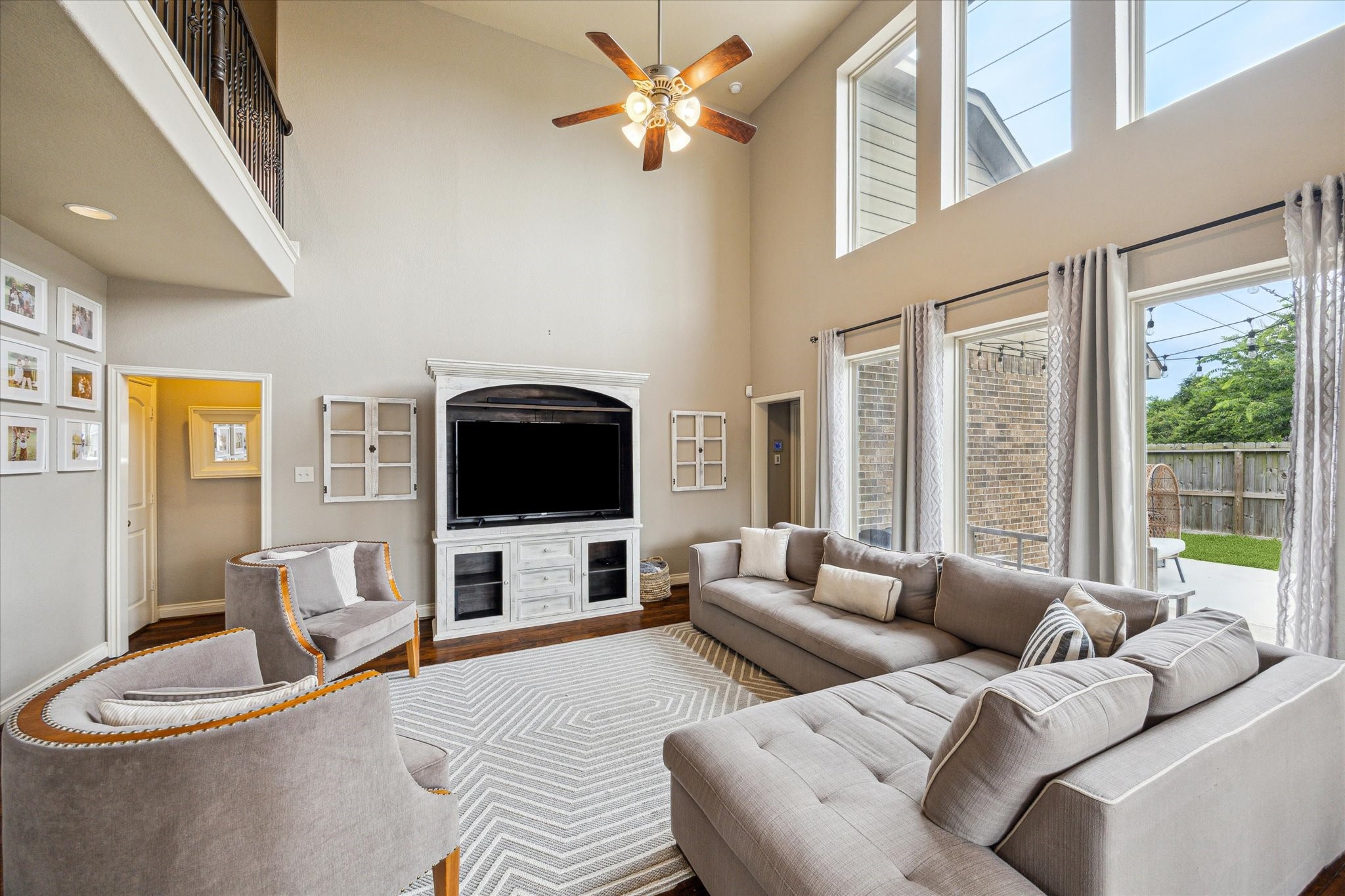 28919 Crested Butte Drive Katy, TX 77494 - Photo 18 of 36 Living room features a
ceiling fan, high ceilings, and a wall
of windows.