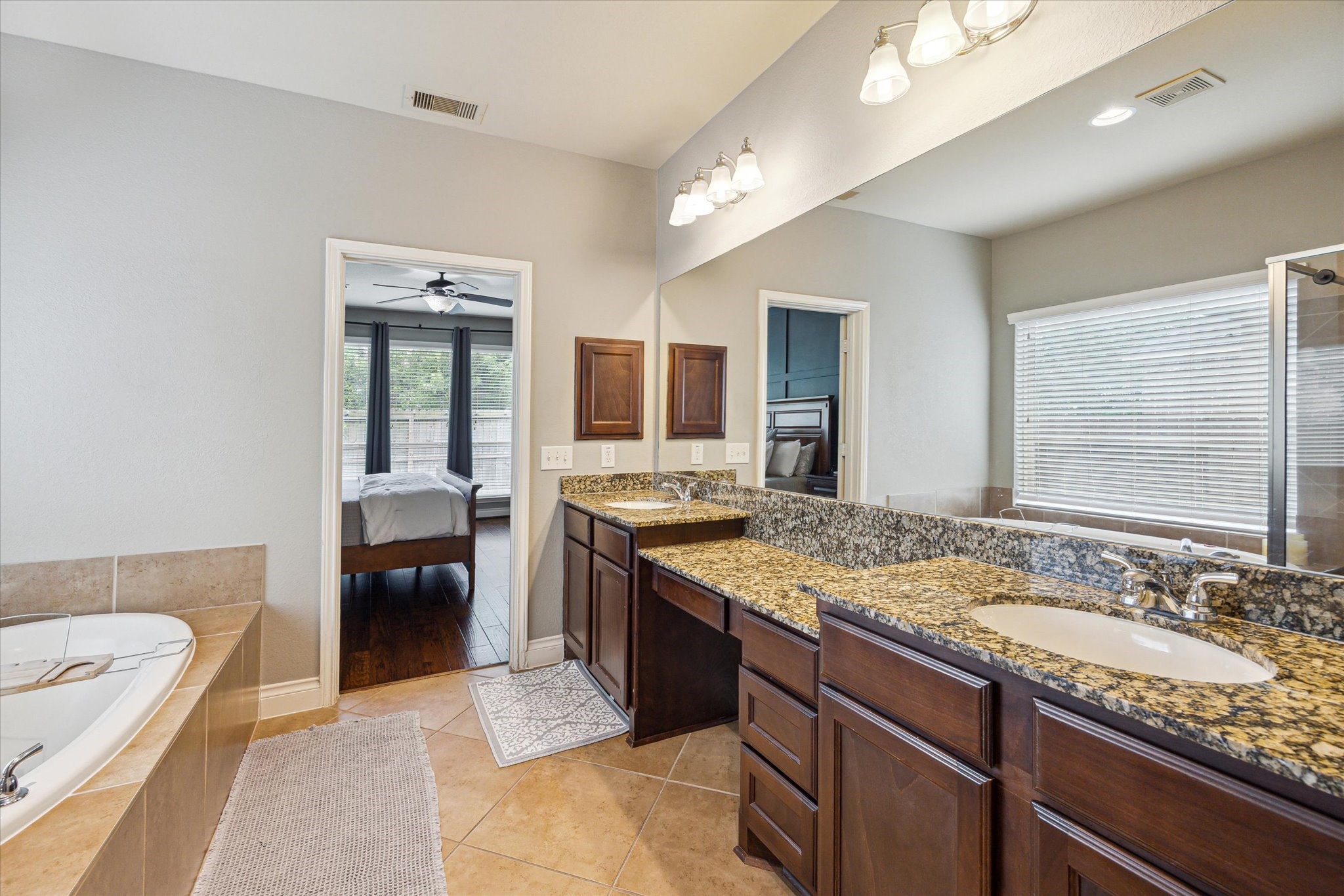 28919 Crested Butte Drive Katy, TX 77494 - Photo 23 of 36 The primary bathroom features tile floors, dual sinks, vanity area, walk-in shower, and separate tub.