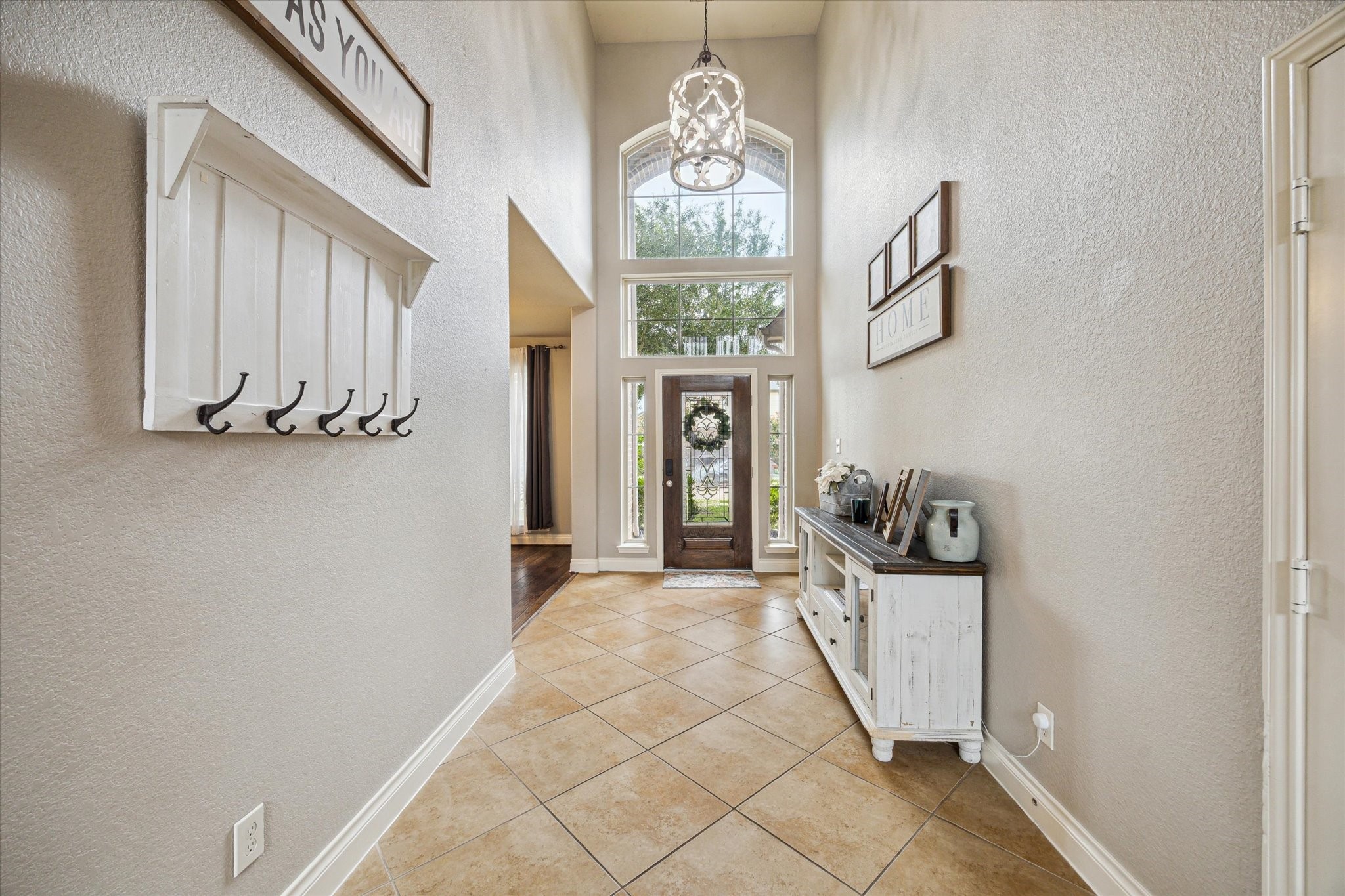 28919 Crested Butte Drive Katy, TX 77494 - Photo 6 of 36 The elongated foyer boasts high
ceilings, tile floors, large windows, and is adorned with tasteful
decor, creating an immediate sense
of elegance.