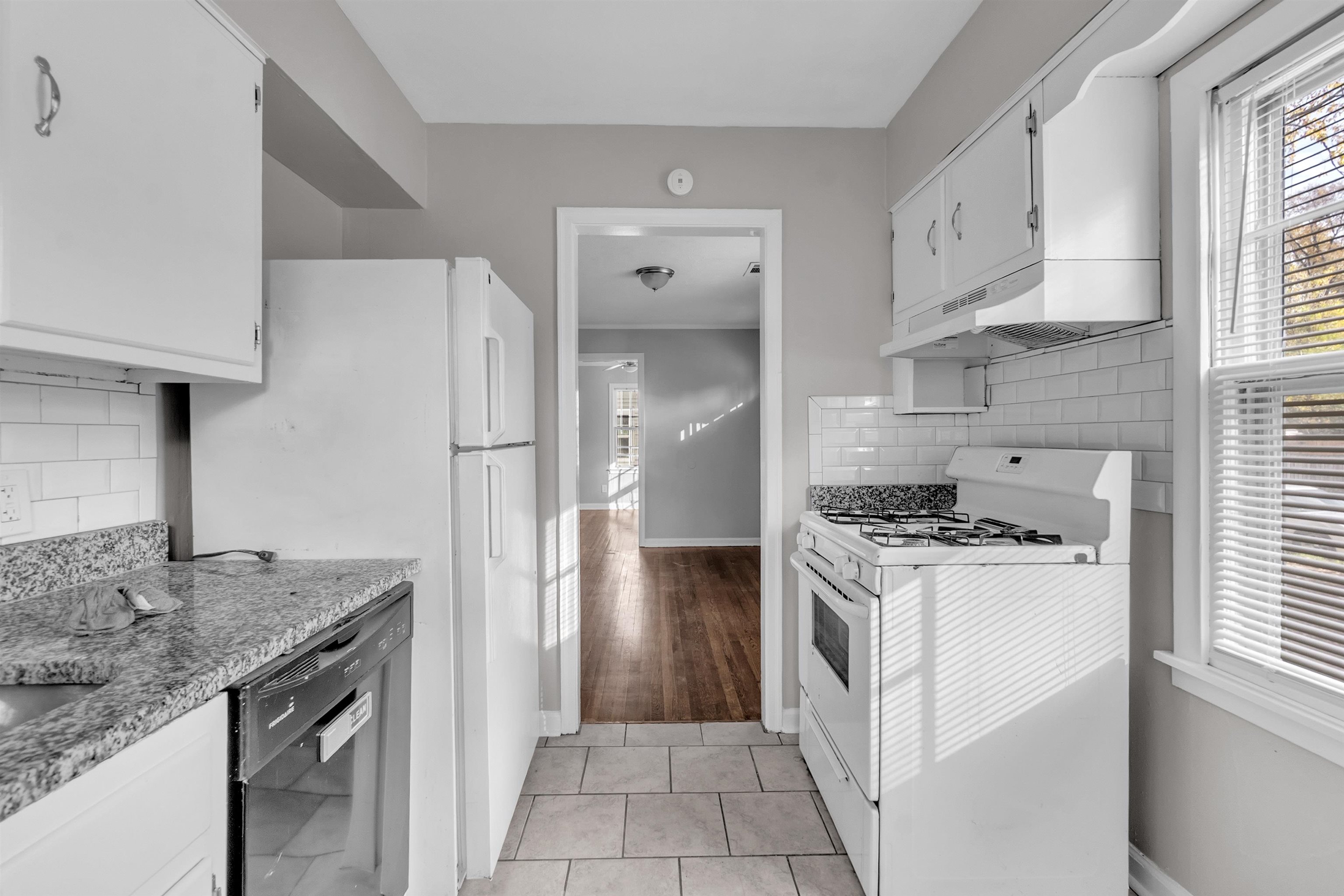3844 Wilshire Road Memphis, TN 38111 - Photo 16 of 18 a kitchen with granite countertop a sink stove and refrigerator