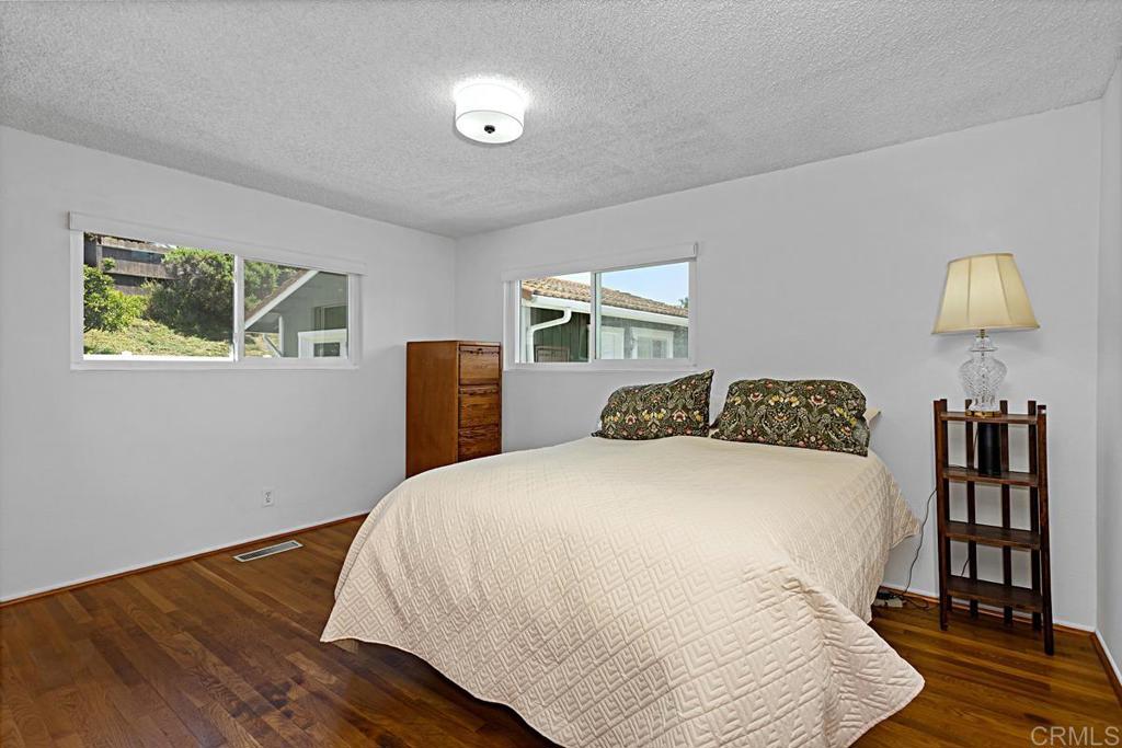1551 Burgundy Road Encinitas, CA 92024 - Photo 16 of 31 a bedroom with a bed and a lamp