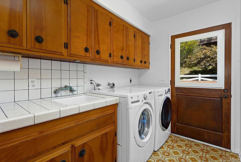 1551 Burgundy Road Encinitas, CA 92024 - Photo 19 of 31 a utility room with dryer and washer
