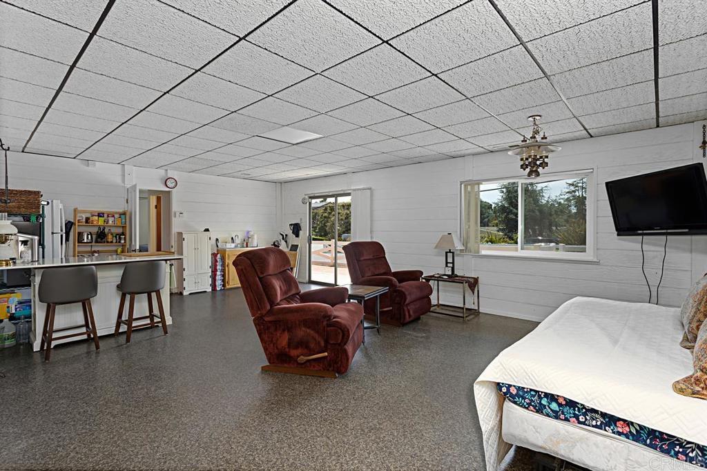 1551 Burgundy Road Encinitas, CA 92024 - Photo 20 of 31 a living room with furniture a flat screen tv and a table