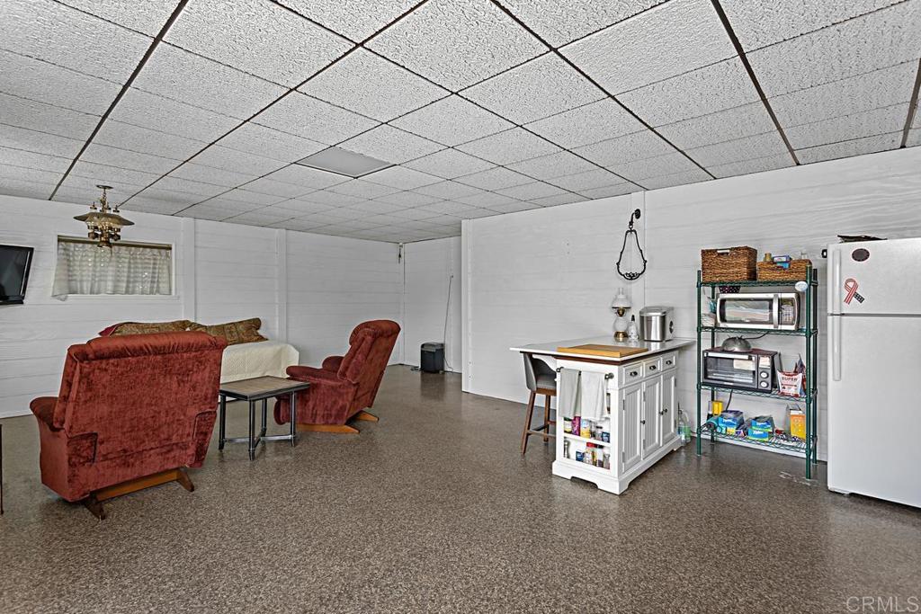 1551 Burgundy Road Encinitas, CA 92024 - Photo 22 of 31 a living room with furniture and a projector screen