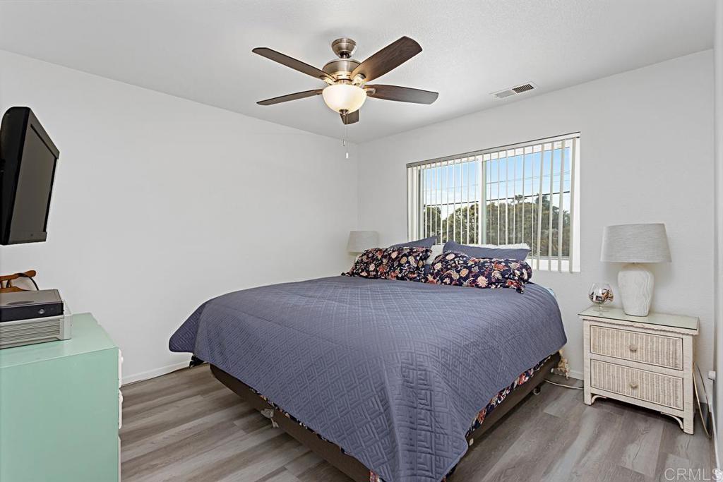 1551 Burgundy Road Encinitas, CA 92024 - Photo 24 of 31 a bedroom with a bed and a flat tv screen on dresser