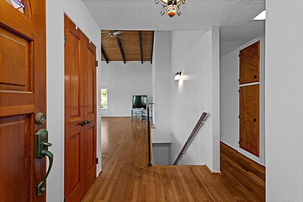 1551 Burgundy Road Encinitas, CA 92024 - Photo 7 of 31 a view of hallway with stairs and wooden floor