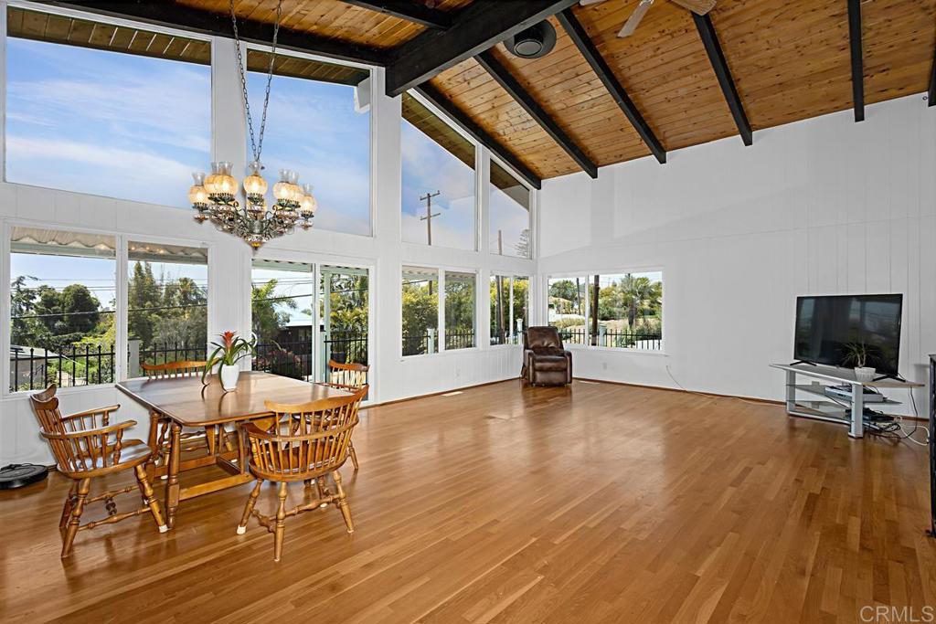 1551 Burgundy Road Encinitas, CA 92024 - Photo 8 of 31 a view of a dining room with furniture wooden floor and chandelier