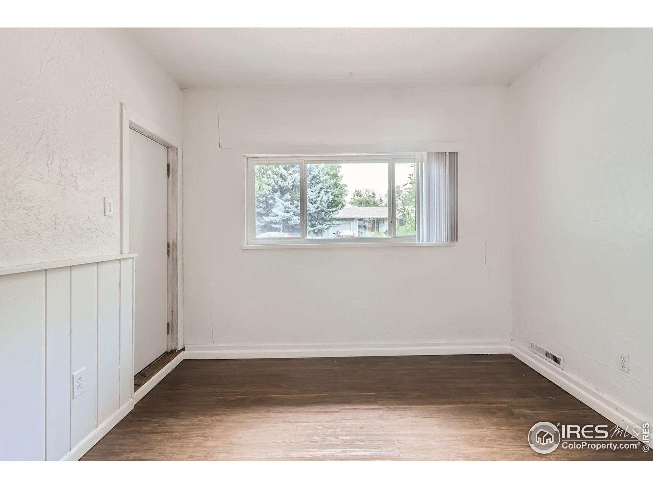 1517 Crestmore Place Fort Collins, CO 80521 - Photo 11 of 28 an empty room with wooden floor and windows