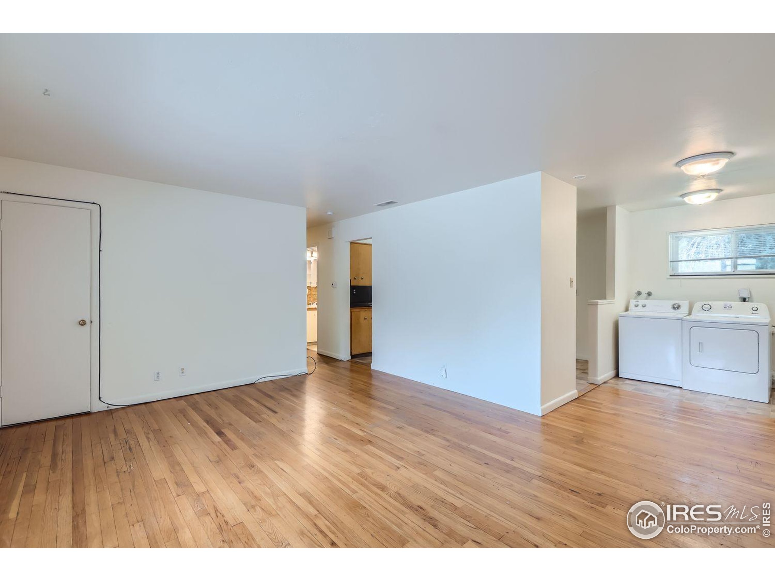 1517 Crestmore Place Fort Collins, CO 80521 - Photo 4 of 28 a view of an empty room with wooden floor
