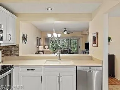 a view of a kitchen with a sink and wooden floor