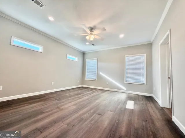 wooden floor in an empty room with a window