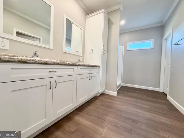a bathroom with a sink a mirror and a shower
