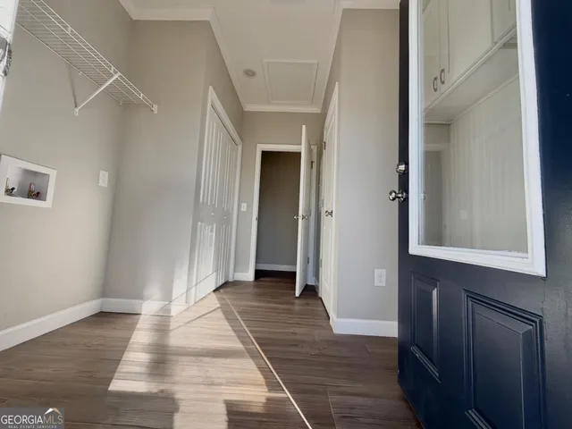 a view of an empty room with wooden floor
