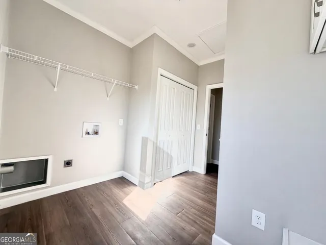 a view of walk in closet with empty racks