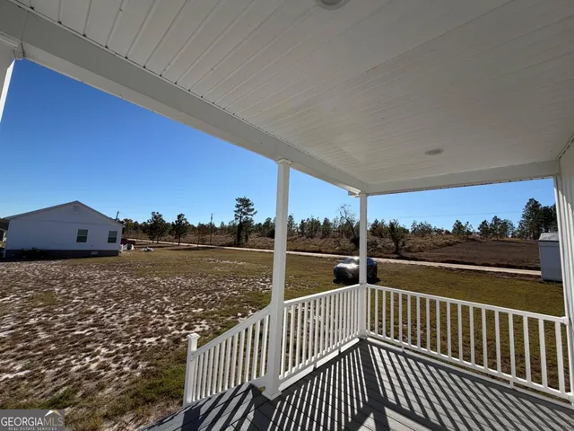 a view of kitchen with wooden floor and electronic appliances