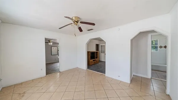a view of empty room with closet and chandelier