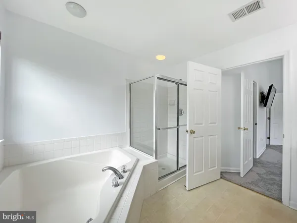 a bathroom with a shower and a tub