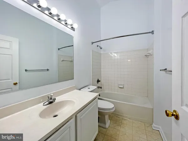 a bathroom with a sink toilet tub and shower