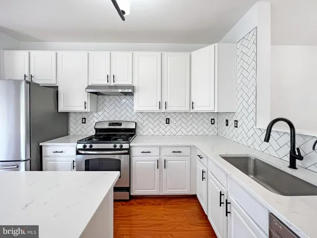 a kitchen with stainless steel appliances granite countertop a stove a sink dishwasher and a refrigerator