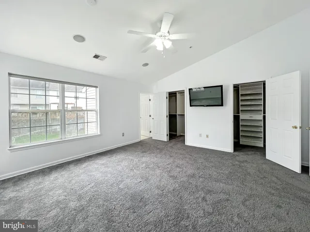 a view of an empty room with a kitchen