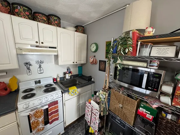 a kitchen with stove and cabinets