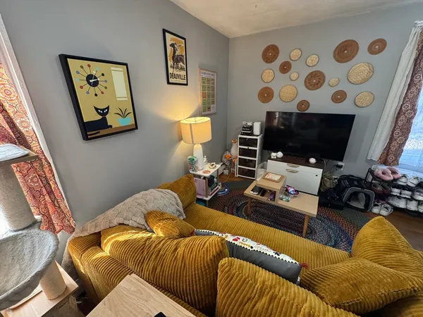 a living room with furniture and a flat screen tv