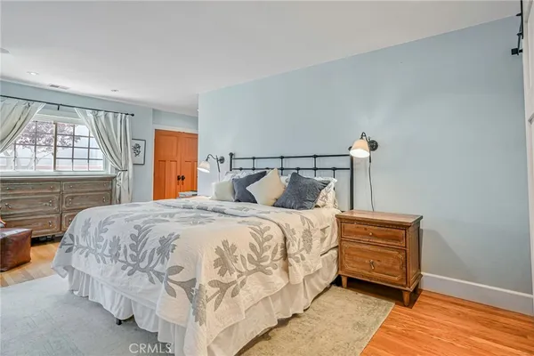 a bed sitting in a bedroom next to a window