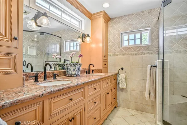 a bathroom with a granite countertop sink mirror and