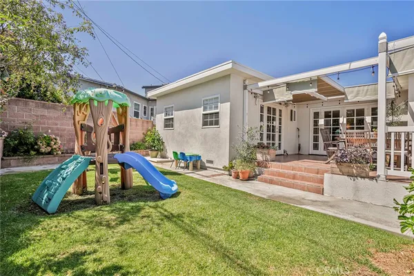 a view of a house with swimming pool and garden