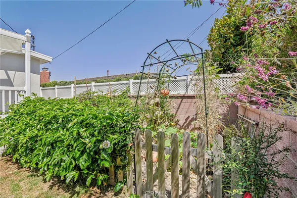 a backyard of a house with lots of green space and wooden fence