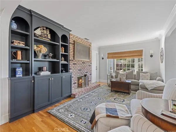 a living room with furniture a rug and a fireplace
