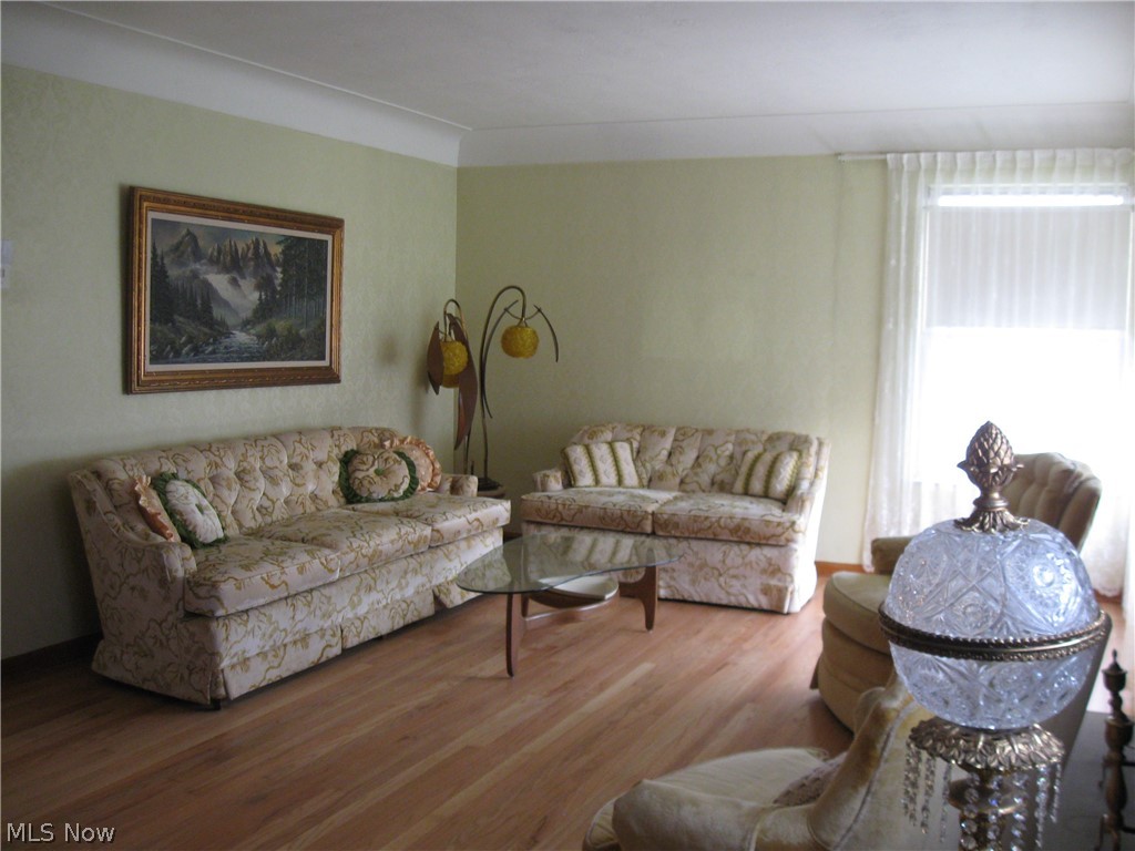 6154 State Road Parma, OH 44134 - Photo 4 of 35 Living room has freshly re-finished, authentic hardwood floor, cove ceiling, FP, and lots of natural light.