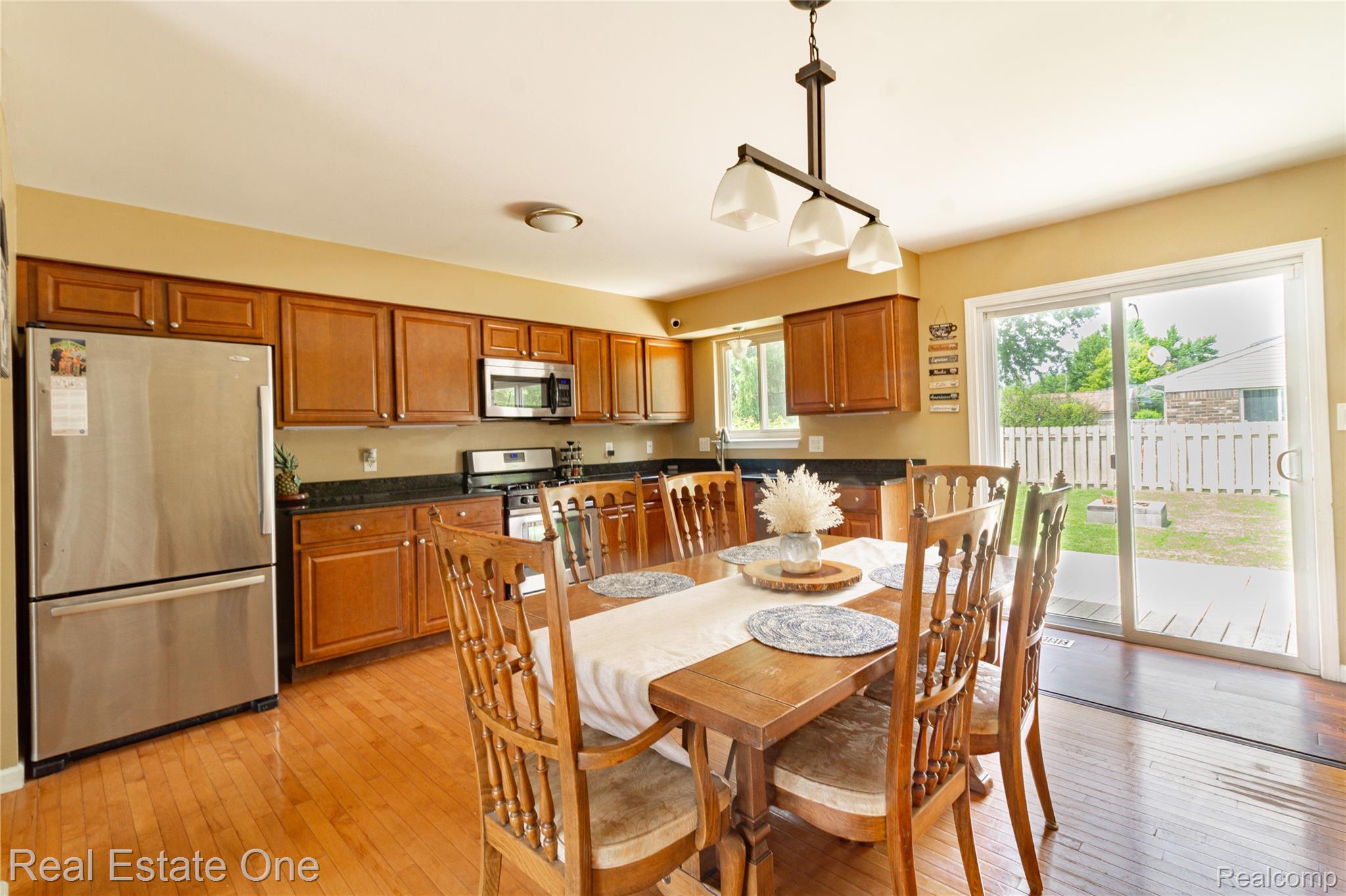 44220 Saltz Road Canton, MI 48187 - Photo 8 of 31 Expansive kitchen featuring wood-finish flooring, abundant cabinetry, and a full suite of stainless steel appliances