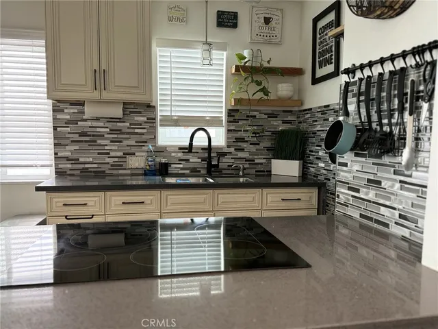a kitchen with stainless steel appliances granite countertop a stove and a sink