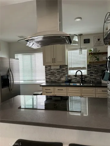 a kitchen with stainless steel appliances granite countertop a sink a stove and a microwave