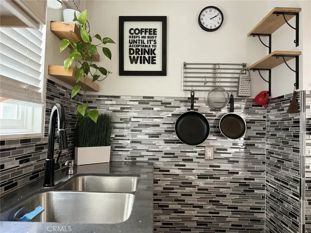 a kitchen with stainless steel appliances cabinets and a window