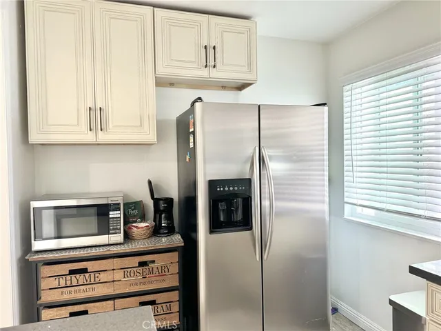a view of washer and dryer with kitchen in the background